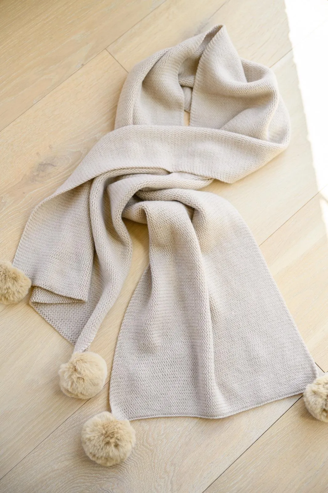 Hazel Blues® | Knitted Fuzzy Pom Pom Scarf In Beige